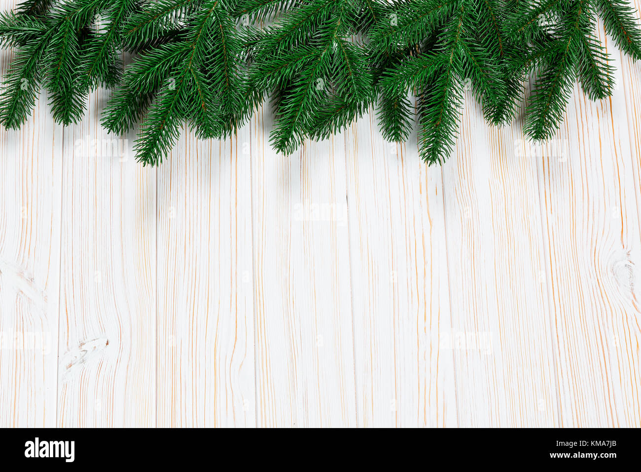 Christmas fir tree on white wooden background. Free space. Winter frame ...