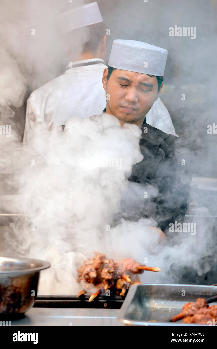 Hui Muslim man with lamb kebab sticks or skewers, Muslim Quarter Bazaar, Beiyuanmen Street, Xi'an, Shaanxi Province, China Stock Photo