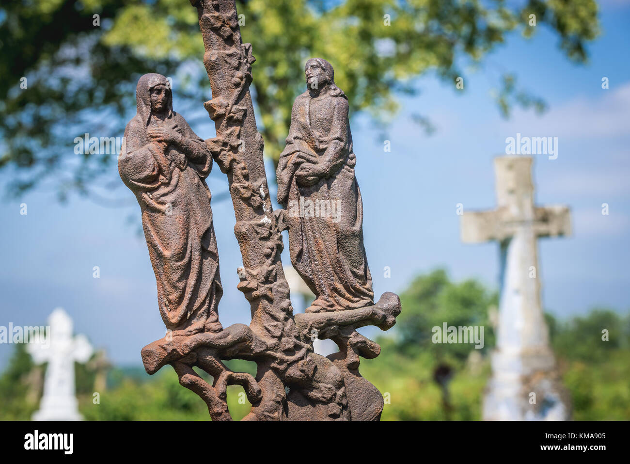 Rusty grave statue on a old cemetery near ruined castle in former Chervonohorod village in Zalischyky region, Ternopil Province, Ukraine Stock Photo