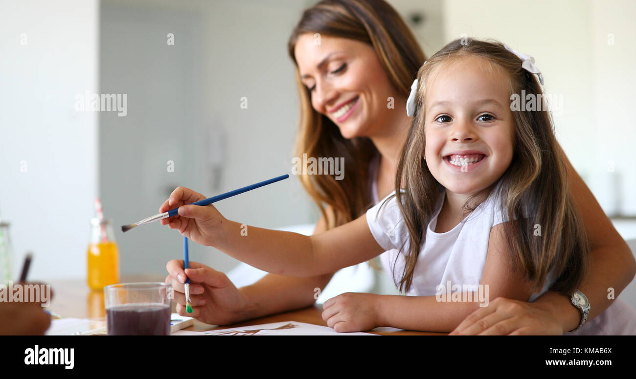 Little girl painting with her mother at home Stock Photo - Alamy