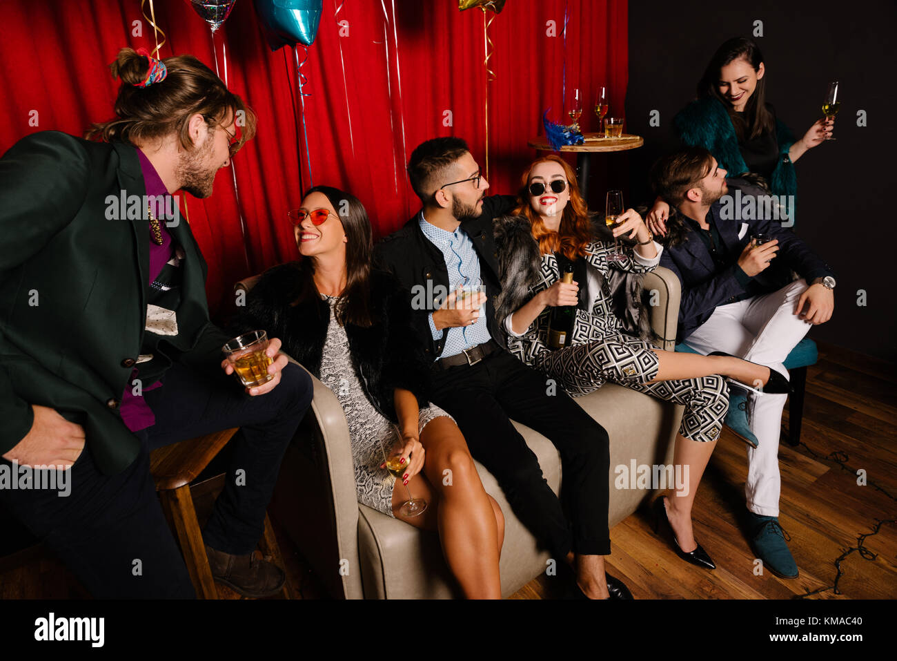 Group of people having a small talk at a party Stock Photo