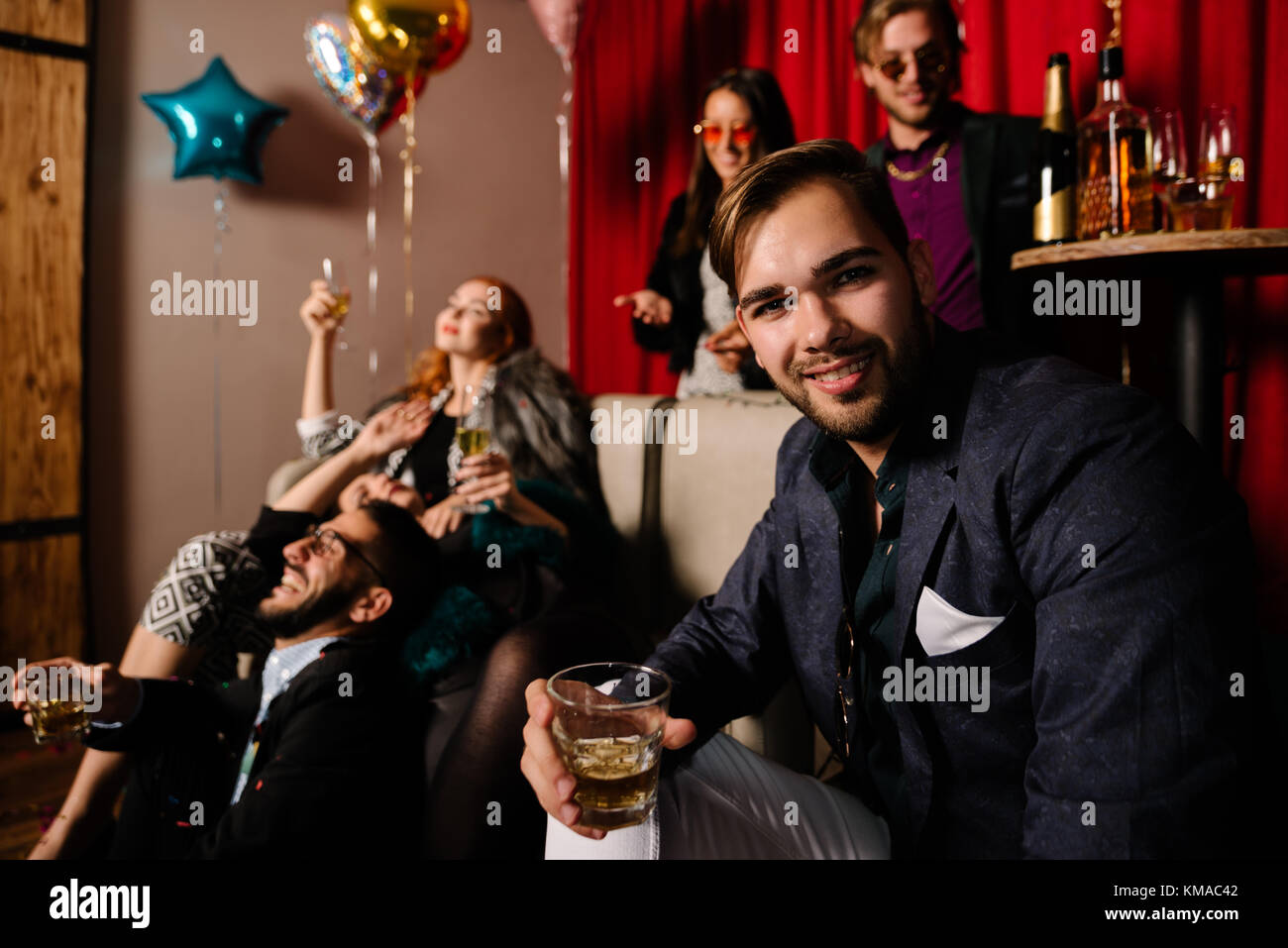 Young man hosting a crazy party Stock Photo