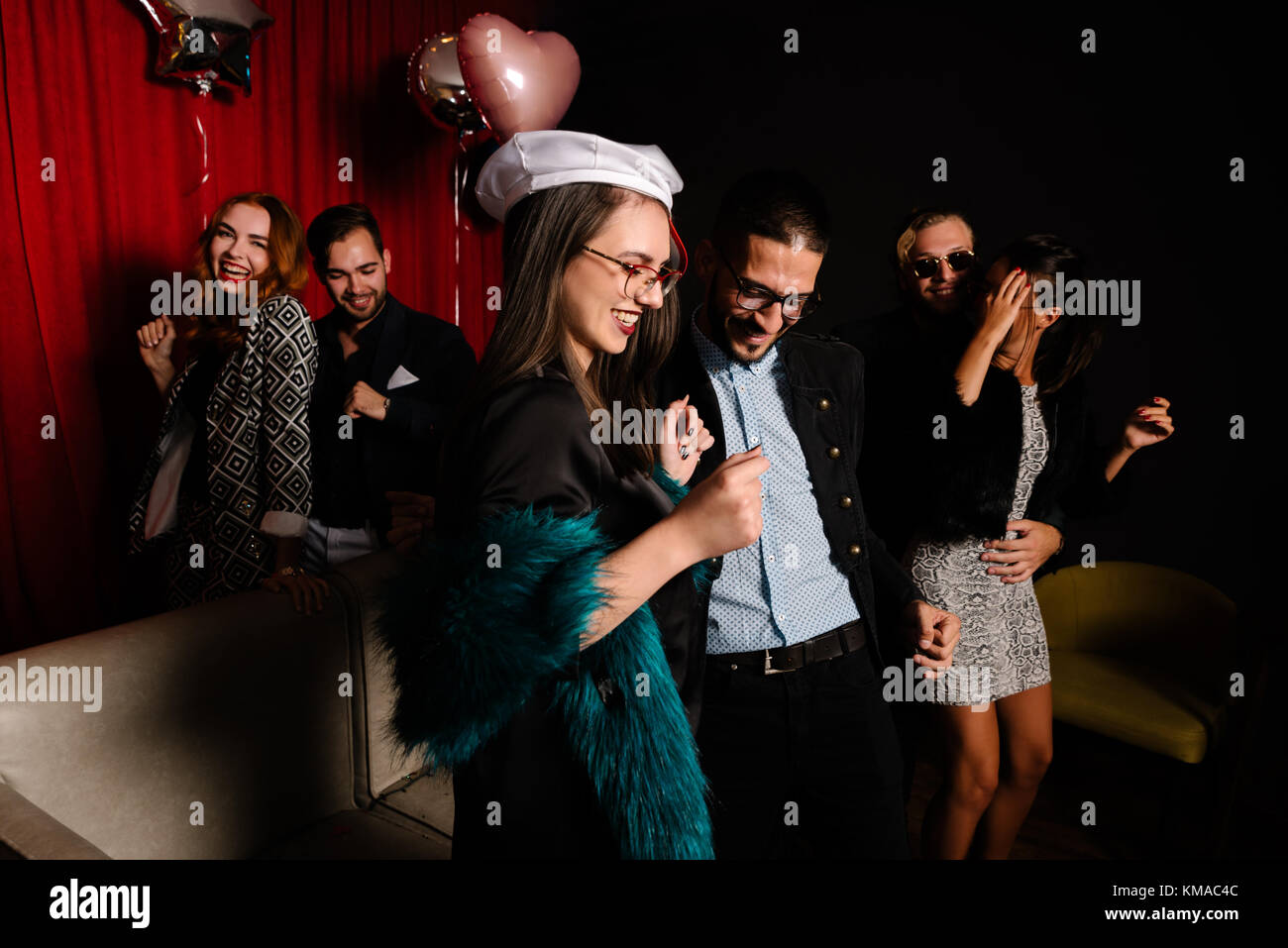 Couple of friends dancing at a party Stock Photo