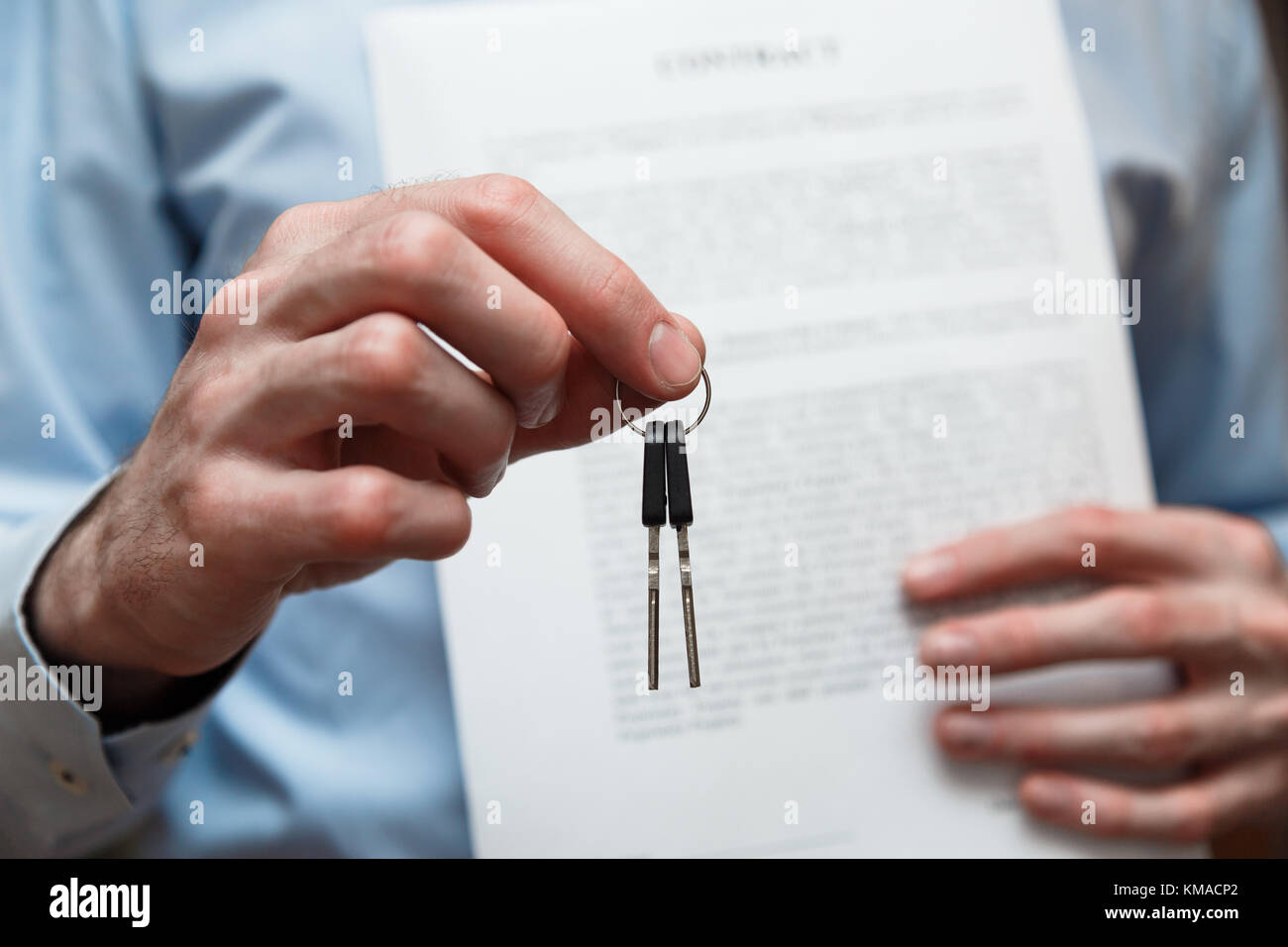 Businessman offering a key with contract. Rental agreement with contract Stock Photo