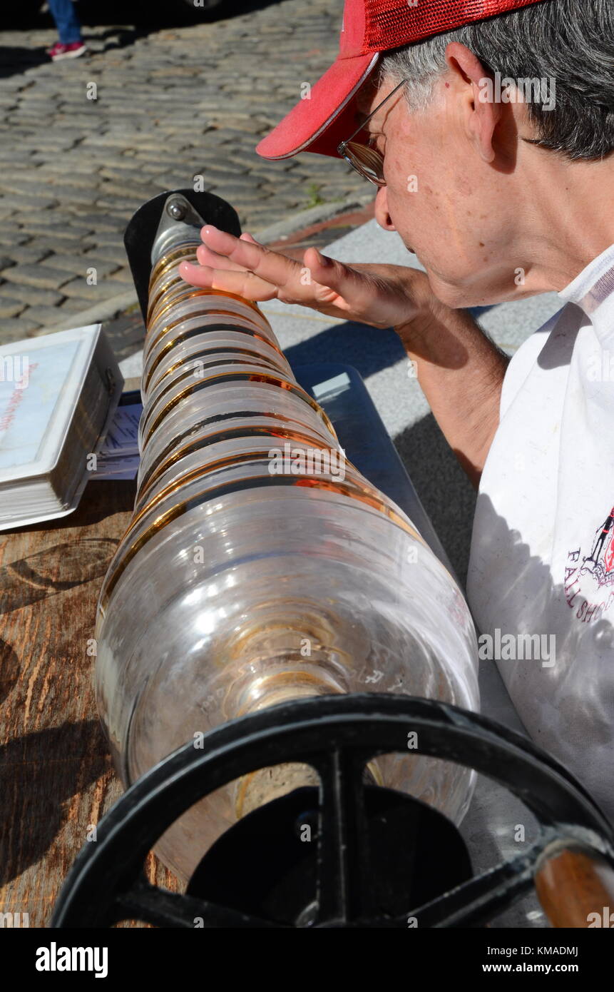 Woman with red baseball cap playing a glass armonica in Rachel Revere