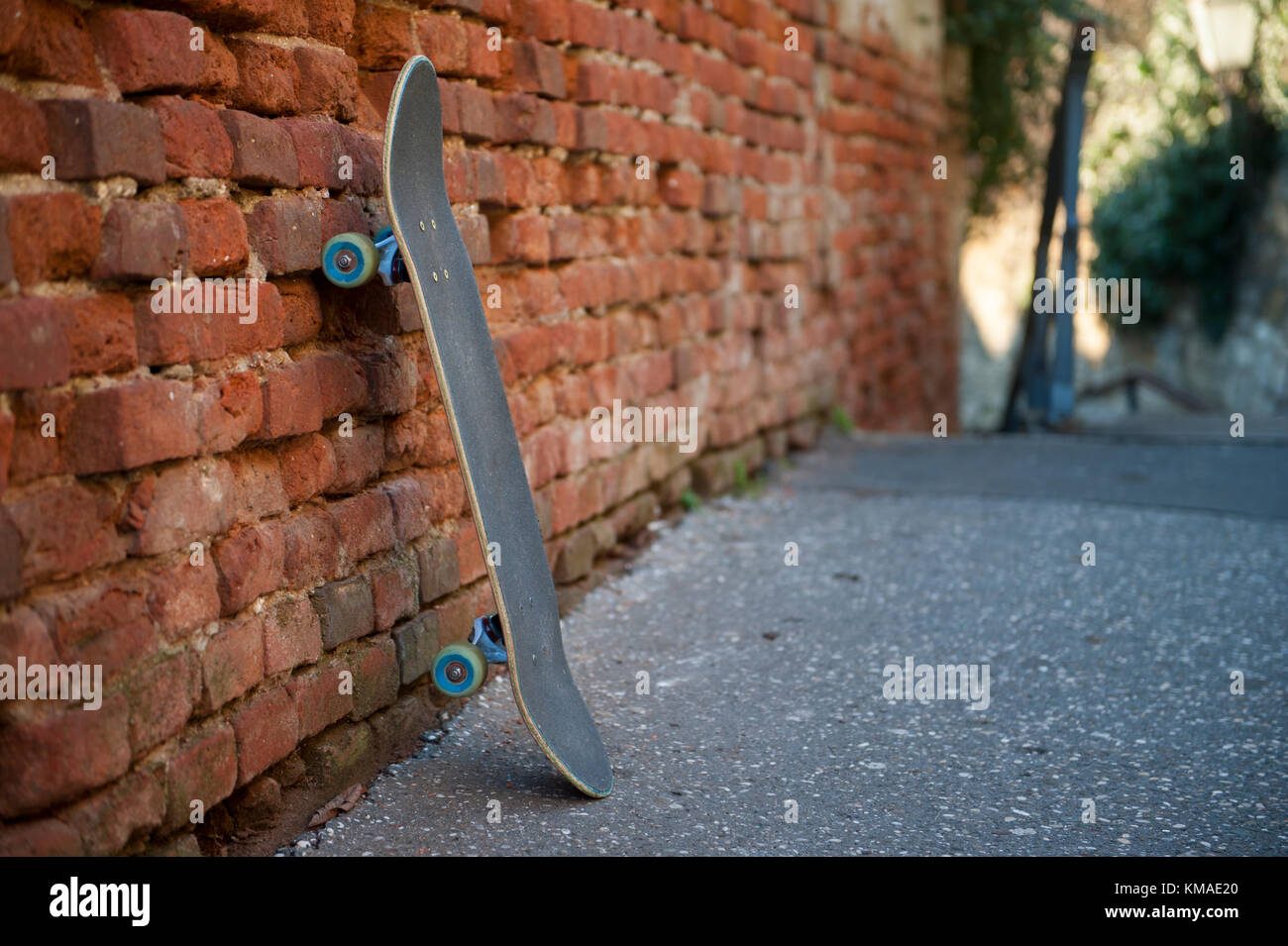Skateboard leaning against wall Stock Photo Alamy