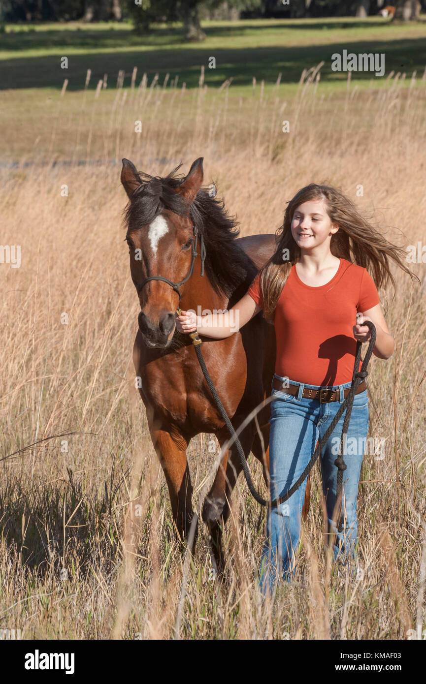 11 year old girl and Arabian horse mare Stock Photo