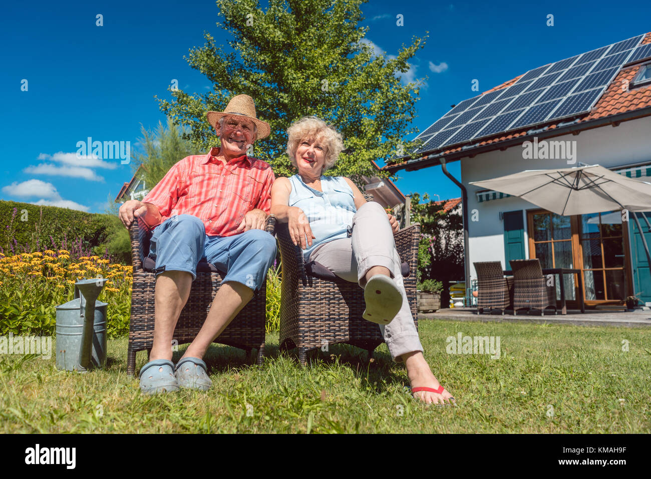 Happy senior couple in love relaxing together in the garden in a Stock ...