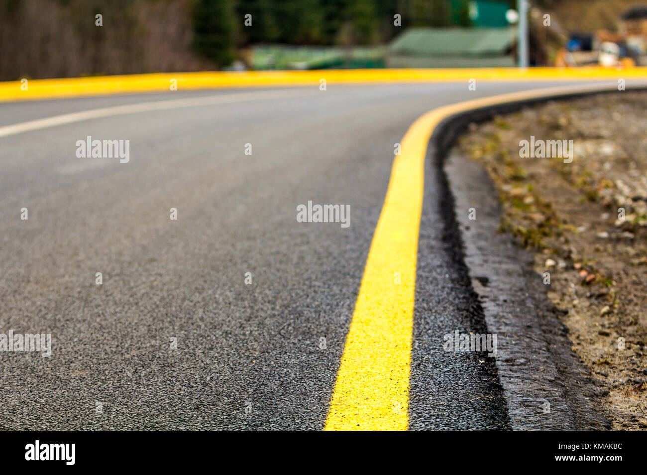 Perspective of asphalt road with yellow line on it Stock Photo - Alamy