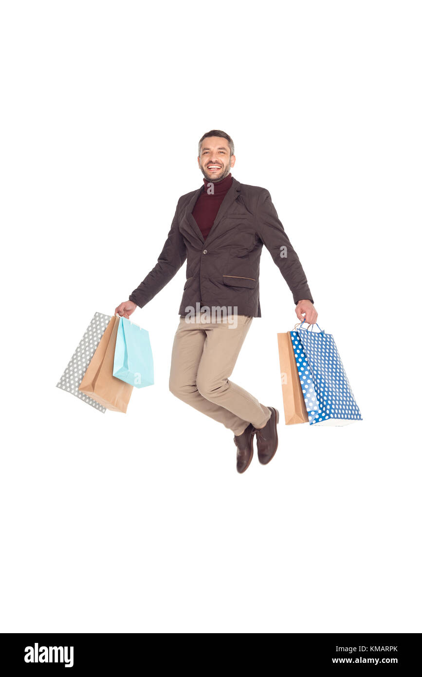 man jumping with shopping bags Stock Photo