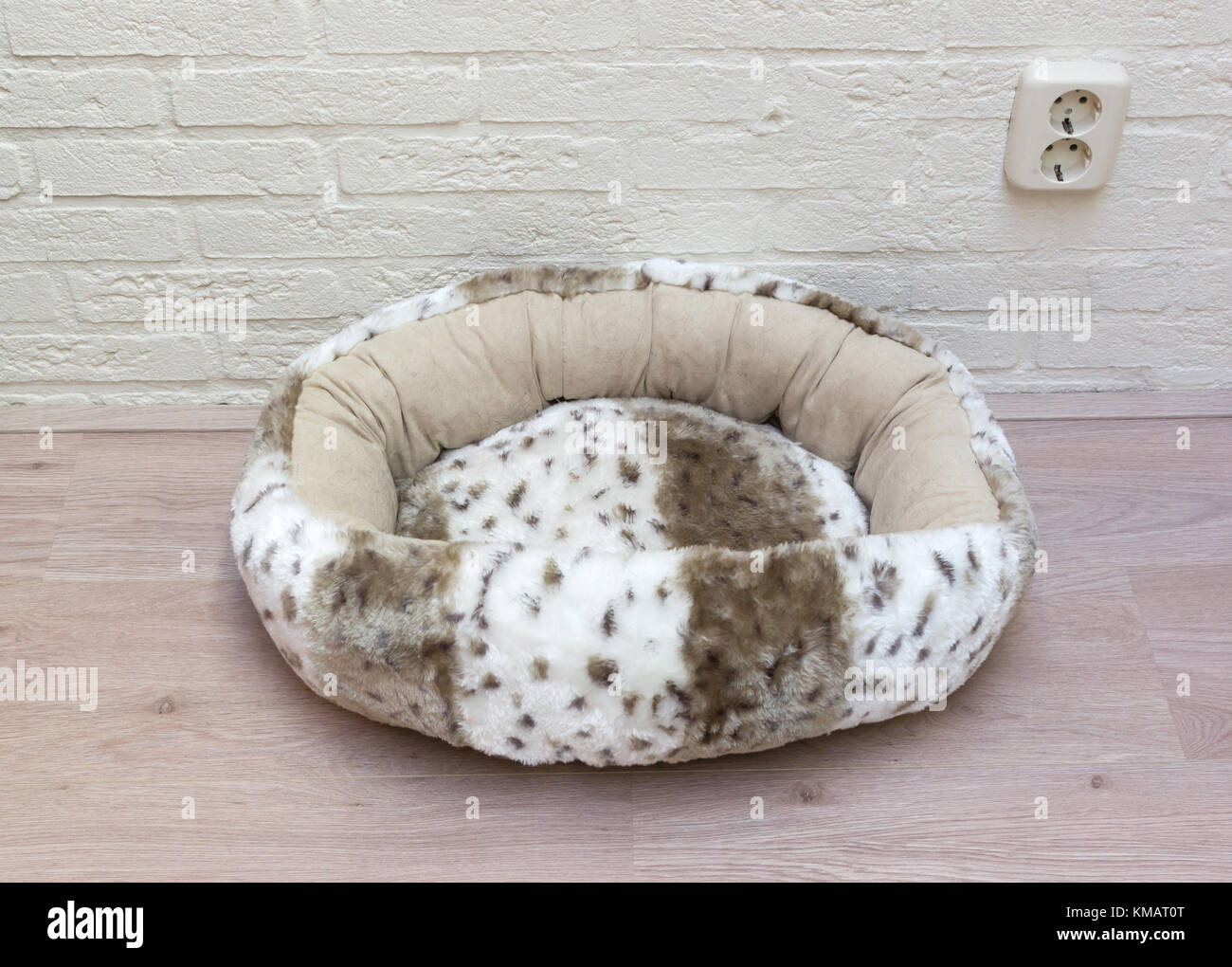 Fluffy basket for a cat, black hairs inside Stock Photo