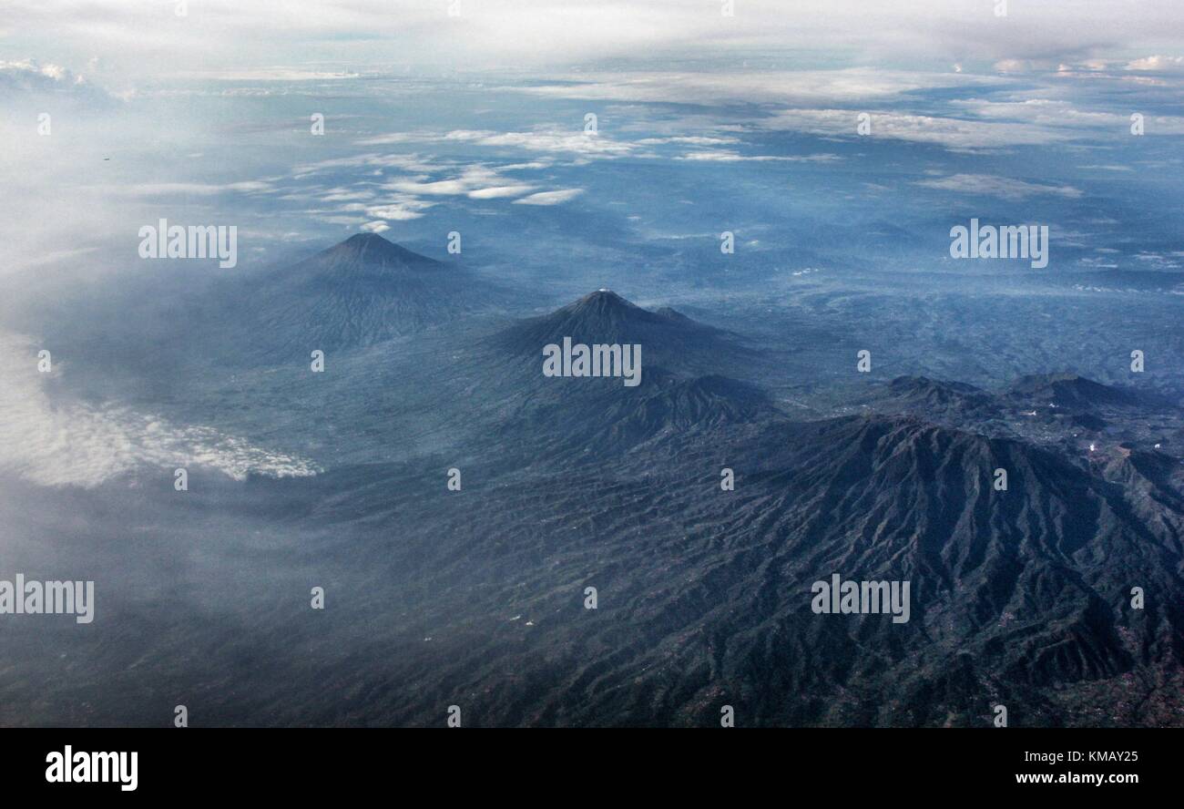 Volcano over Java island. These area mount Sindoro, mount Sumbing and Dieng Plateu. Stock Photo