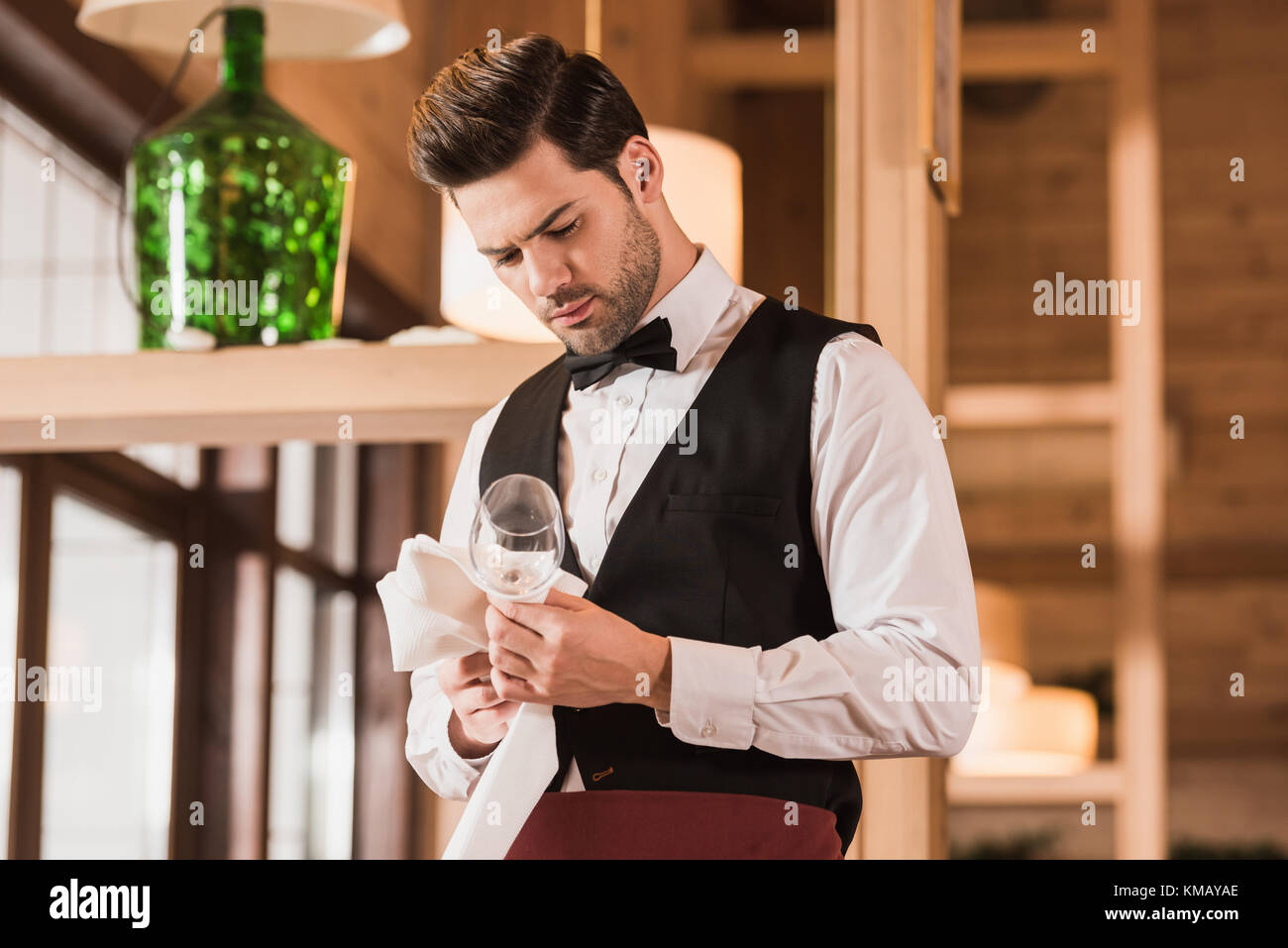 waiter cleaning wineglass Stock Photo