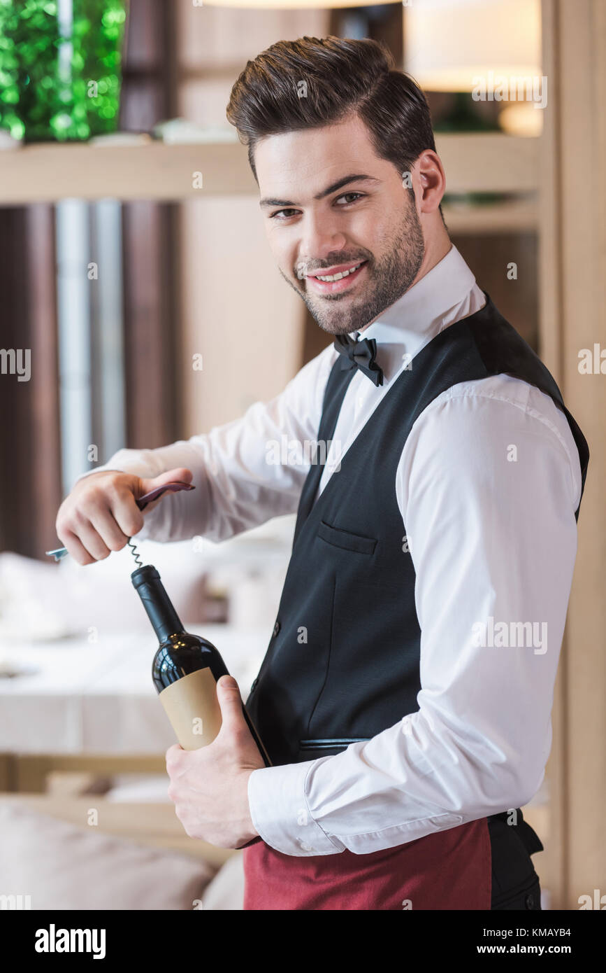 waiter opening bottle of wine Stock Photo Alamy