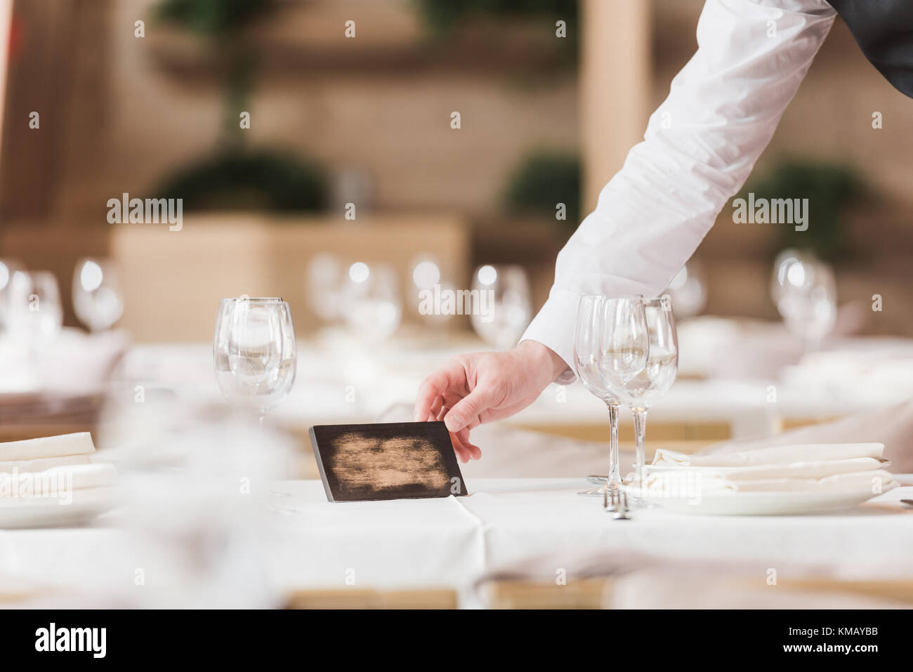 Waiter putting reserved sign Stock Photo