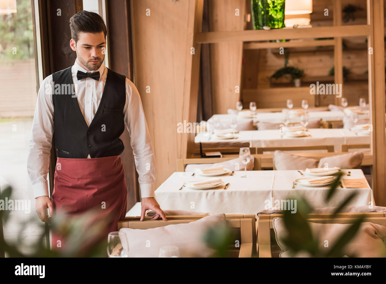 Waiter looking at served table Stock Photo Alamy