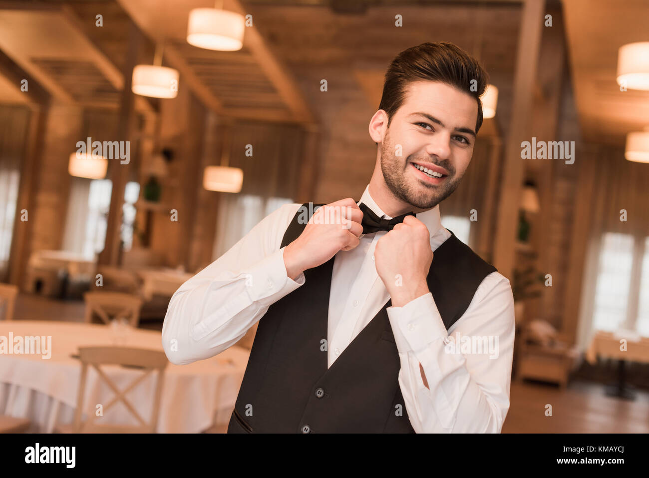 waiter fixing bow tie Stock Photo