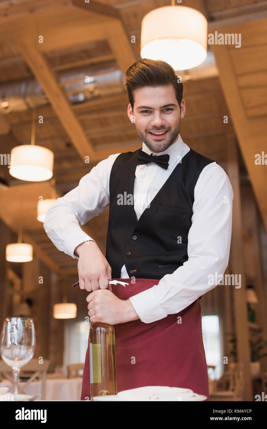 waiter opening bottle of wine Stock Photo Alamy