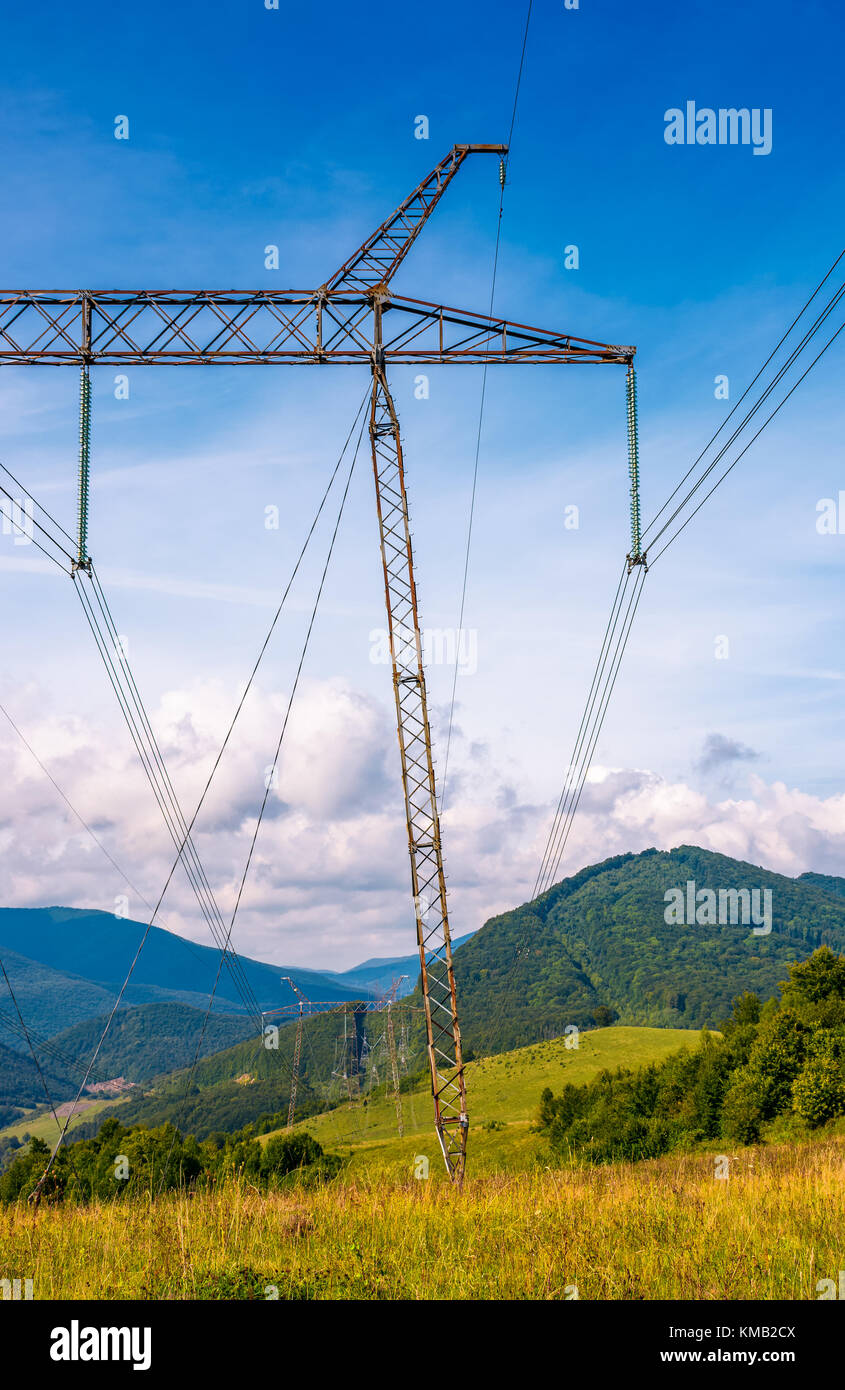 high voltage power lines tower in Carpathian mountains. lovely green ...
