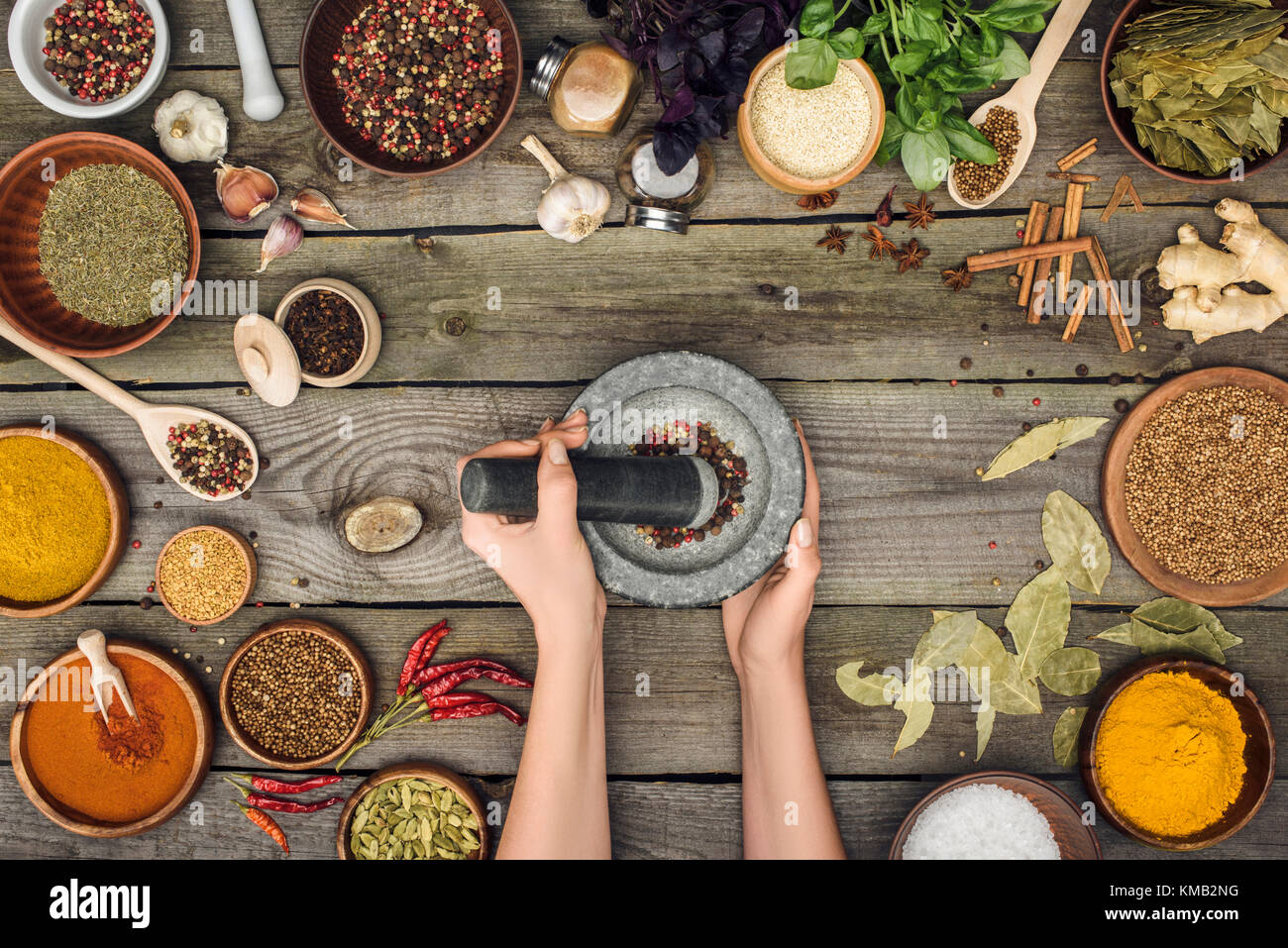 woman grinding pepper with pestle and mortar Stock Photo Alamy