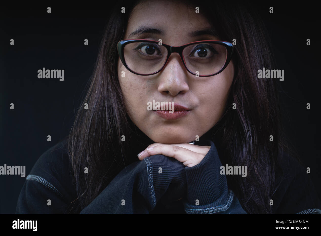 Girl wearing spectacles looking at the camera. Stock Photo