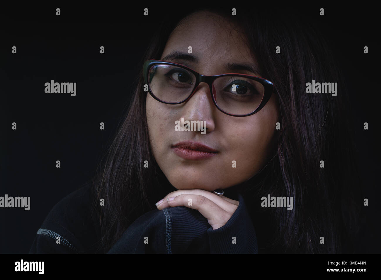 Girl wearing spectacles looking at the camera. Stock Photo