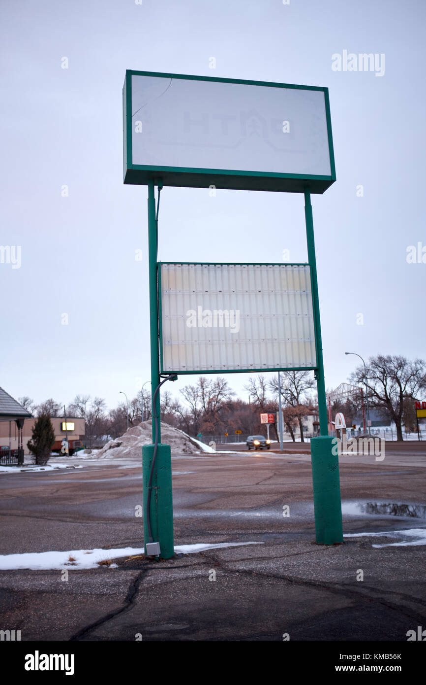 Double billboard with white copy space in a rural asphalt parking lot
