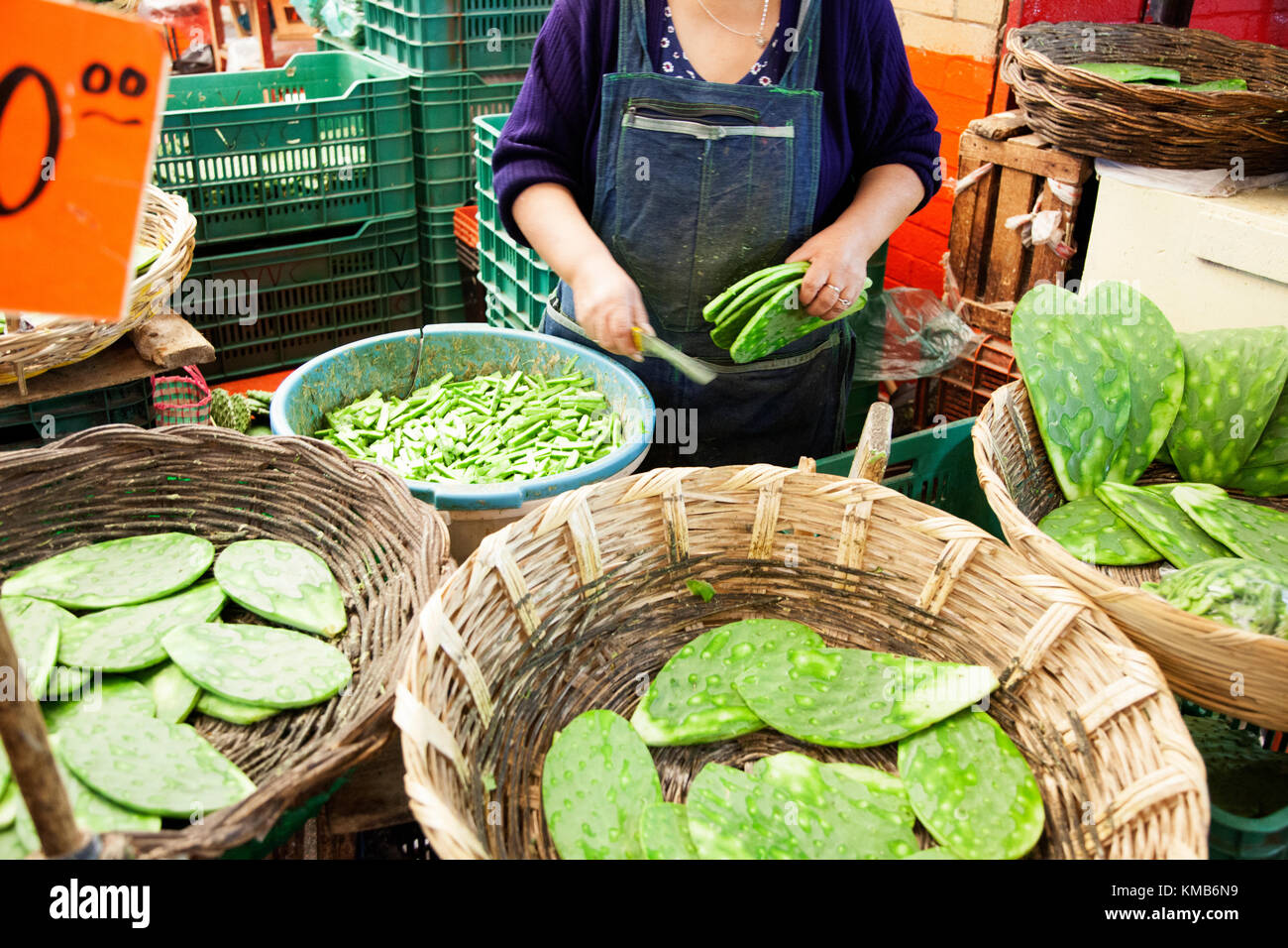 Nopales, Opuntia cacti, being prepared for sale in Mexico City's Mercado de la Merced. Stock Photo