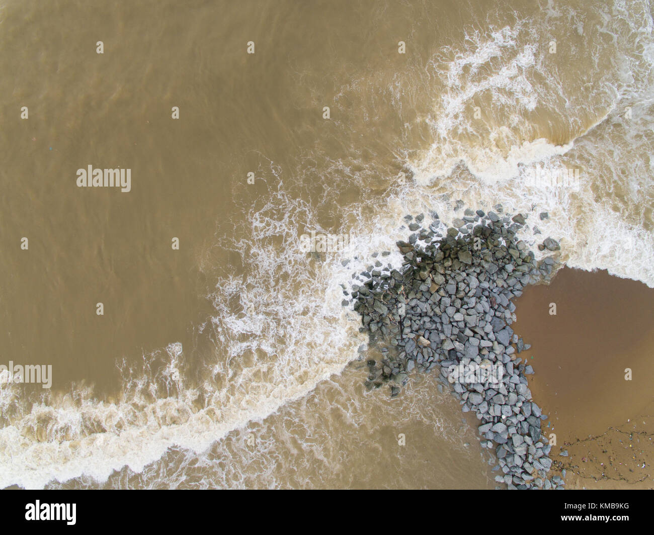 Aerial top view of sea waves hitting rocks on the beach in Pantai ...