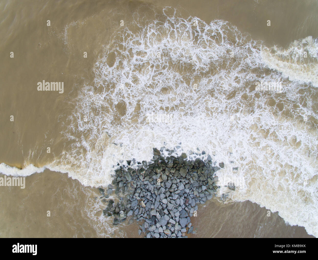 Aerial top view of sea waves hitting rocks on the beach in Pantai ...