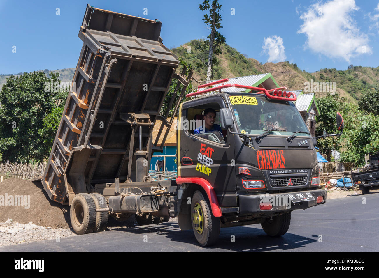East Lombok, September 20th, 2017: Man unloading sand from Dump truck in Sembalun Lombok. Stock Photo