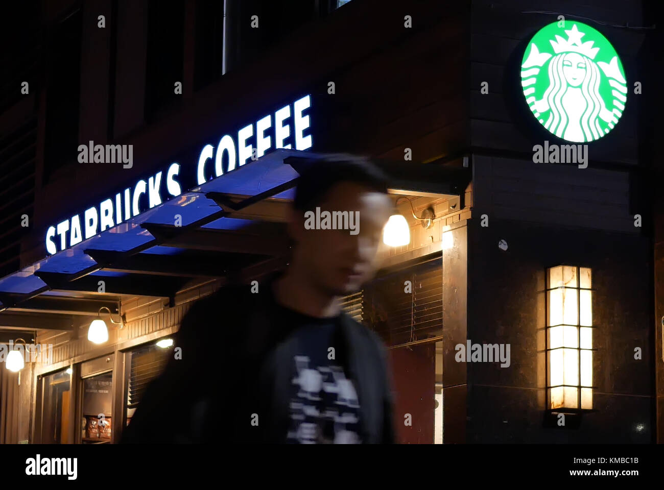 Taipei, Taiwan - October 27, 2017 : Motion of customer walking through Starbucks coffee shop at night Stock Photo