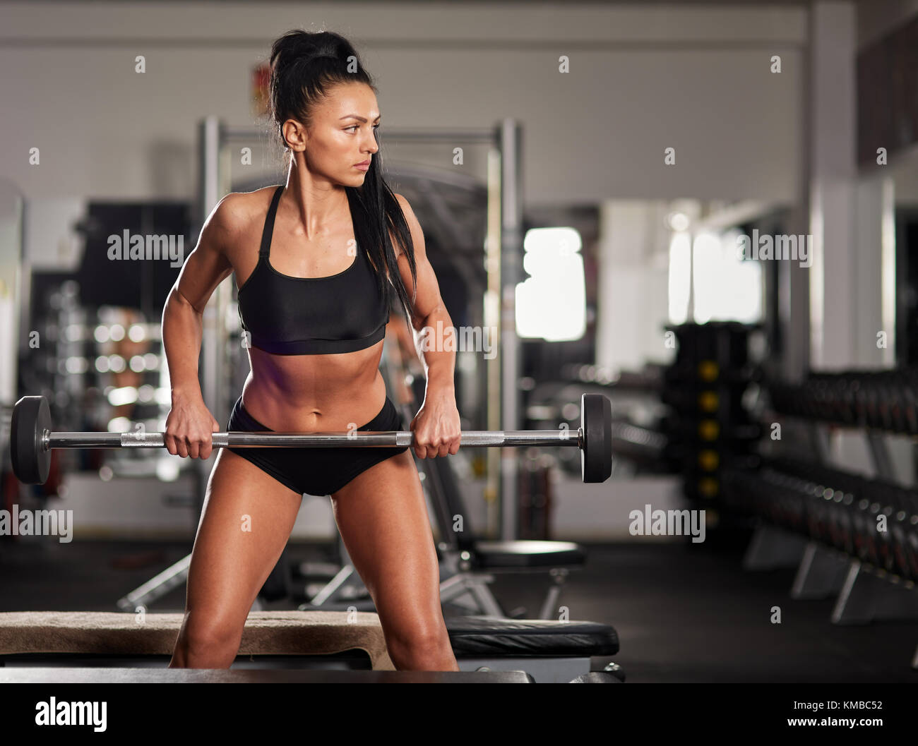 Athletic woman doing barbell rows in the gym Stock Photo Alamy