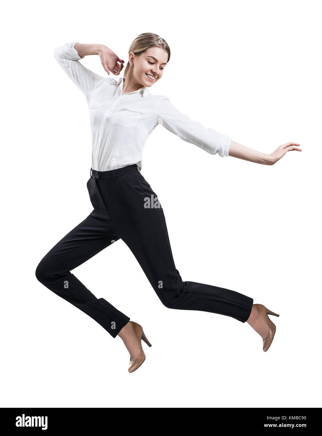 Happy young woman in formal wear jumping . Stock Photo