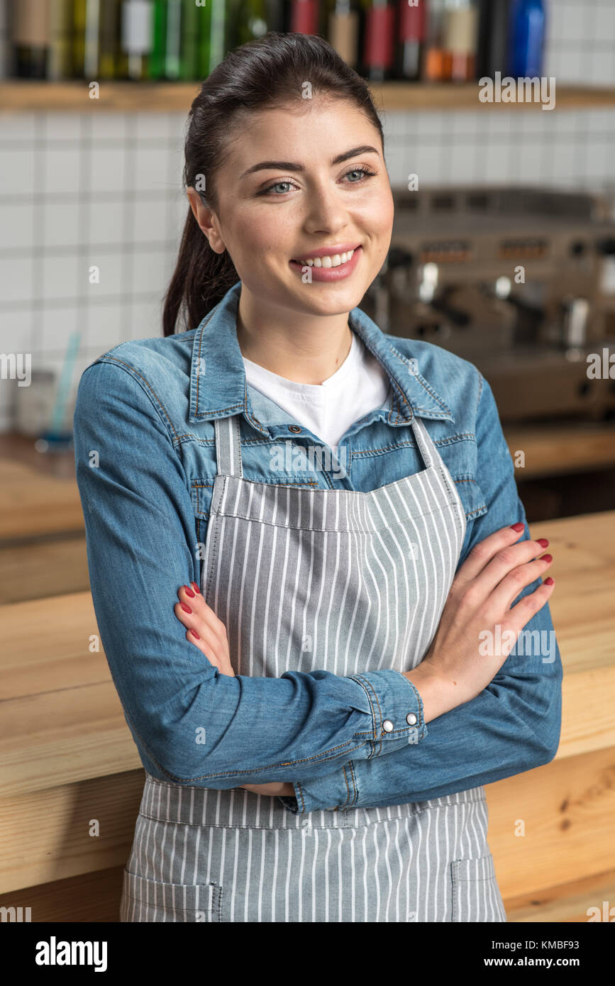 Cute young waitress standing with her arms crossed and smiling Stock ...
