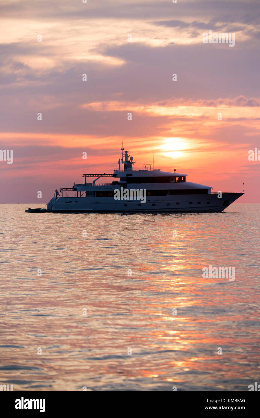 Luxury motor yacht ship cruising the sea at sunset in Phuket, Thailand. Stock Photo