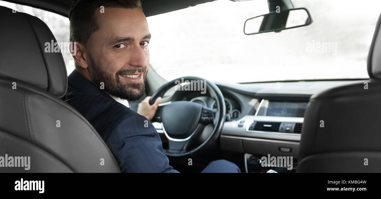 businessman sitting at the wheel of a prestigious car Stock Photo - Alamy