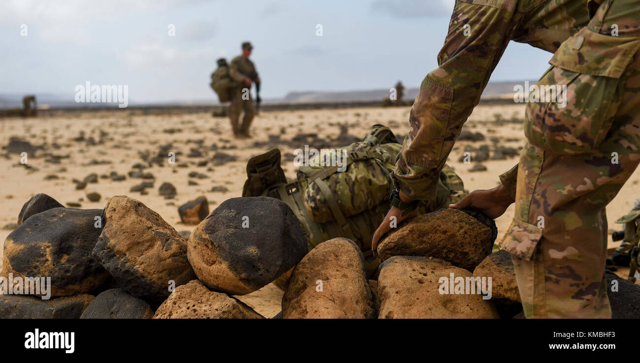 U.S. Army National Guard Spc. Keifer Davis, 3rd Battalion, 144th Infantry Regiment, Task Force Bayonet, stacks rocks as he sets up a defensive position on the first day of a French Desert Commando Course at the Djibouti Range Complex near Arta, Djibouti, Nov. 26, 2017. The 12-day course will expose service members to the fundamentals of desert combat, survival, and troop movements while also bridging language and cultural barriers between the French and American troops. (U.S. Air Force Stock Photo