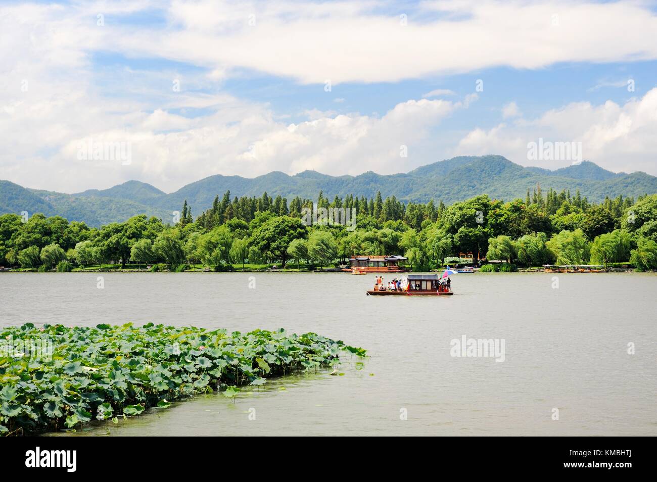 Hangzhou, Zhejiang, China.  Pleasure passenger boats cruise the scenic shores of West Lake in the city of Hangzhou Stock Photo