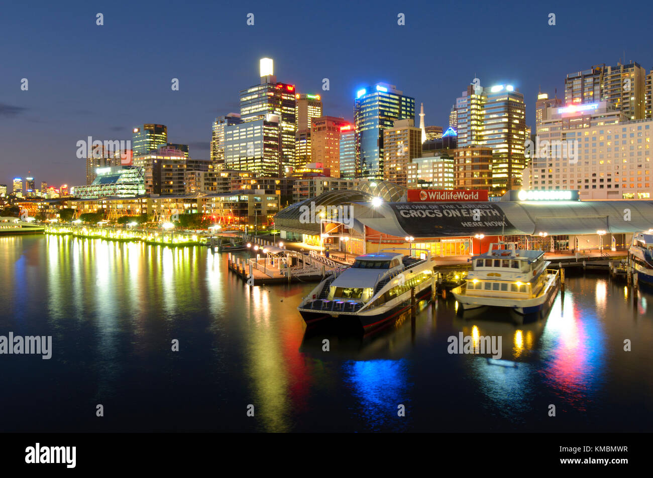 Darling Harbour at Night, Sydney, New South Wales, Australia. Sydney CBD (downtown) after sunset is highlighted with lights and neon signs. Stock Photo