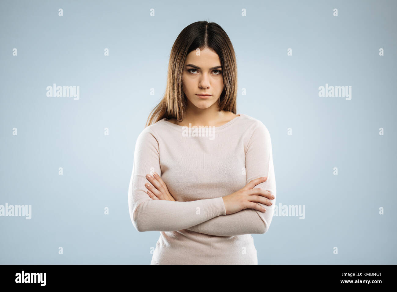 Serious female person crossing her arms Stock Photo