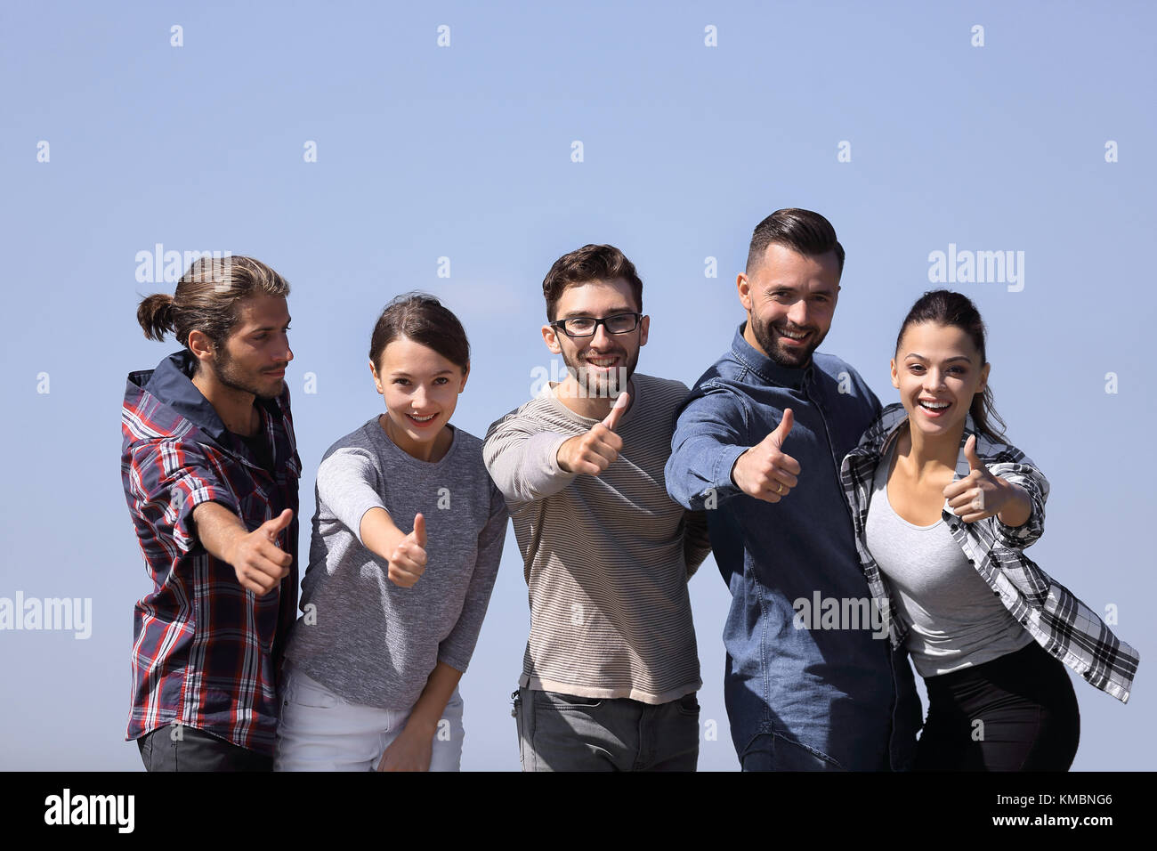 smiling group of young people showing thumb up Stock Photo - Alamy