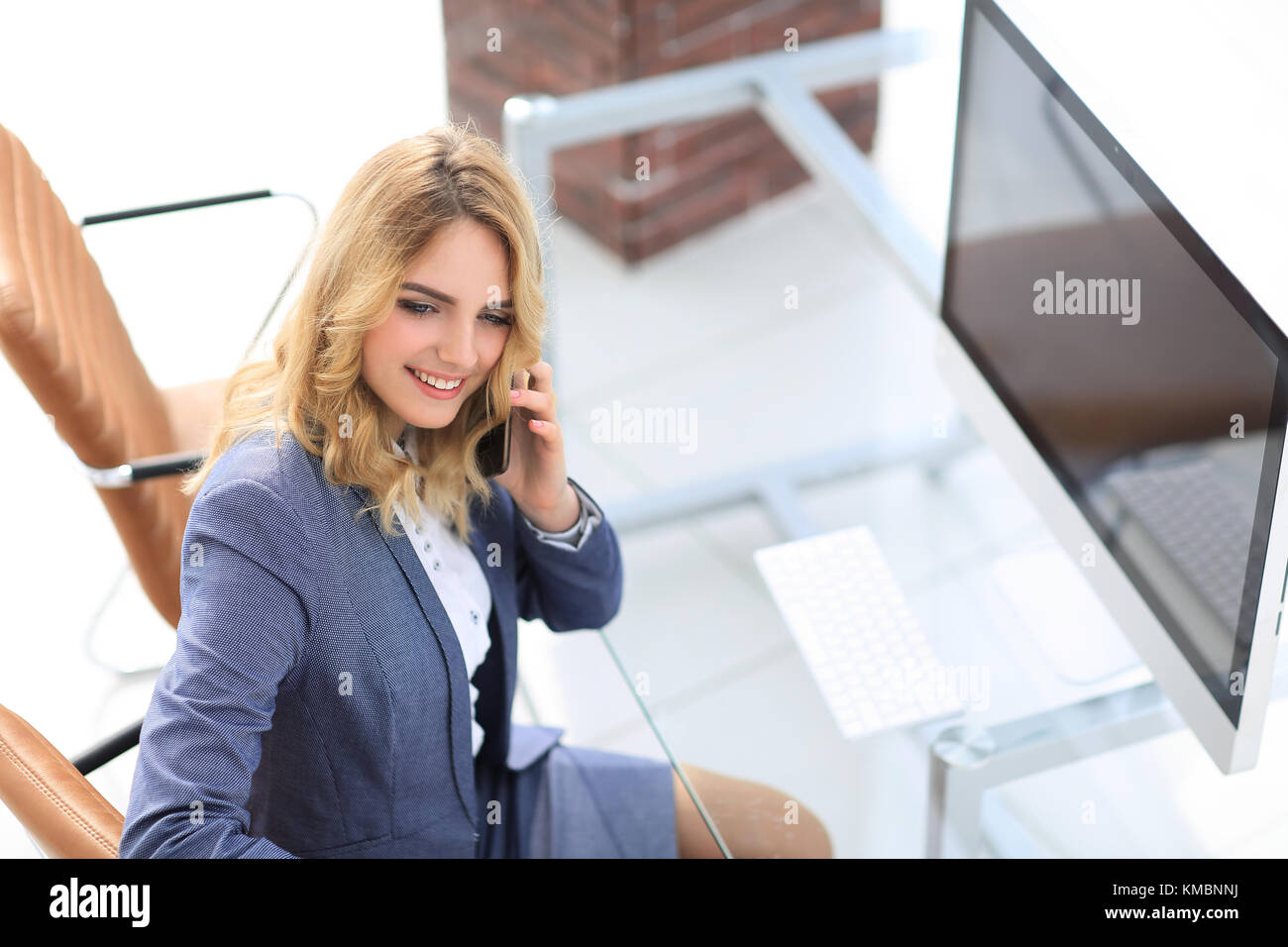 successful young business woman sitting at a Desk Stock Photo - Alamy