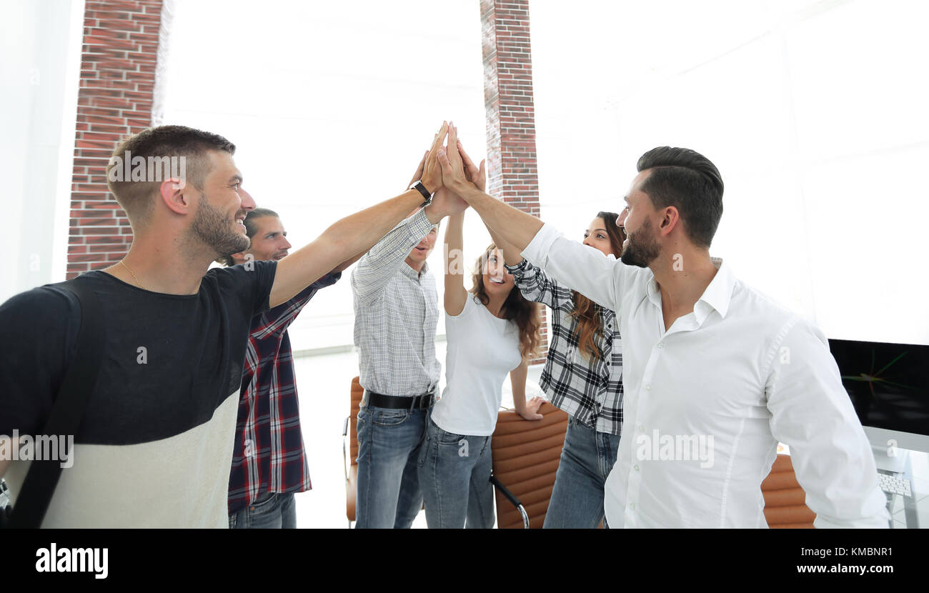 creative team giving each other a high five Stock Photo - Alamy