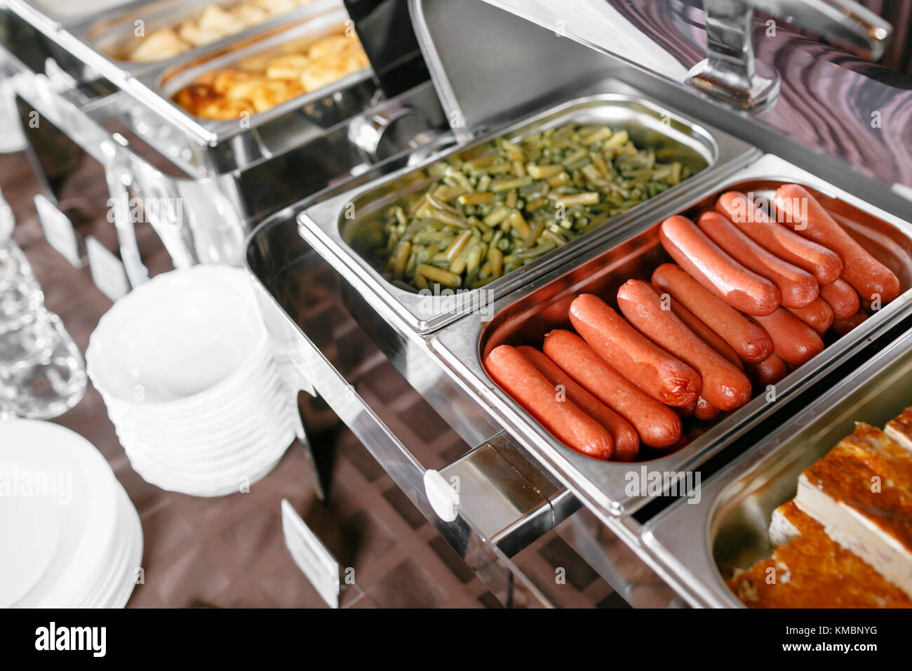 Many buffet heated trays ready for service. Breakfast in hotel catering buffet, metal containers with warm meals Stock Photo