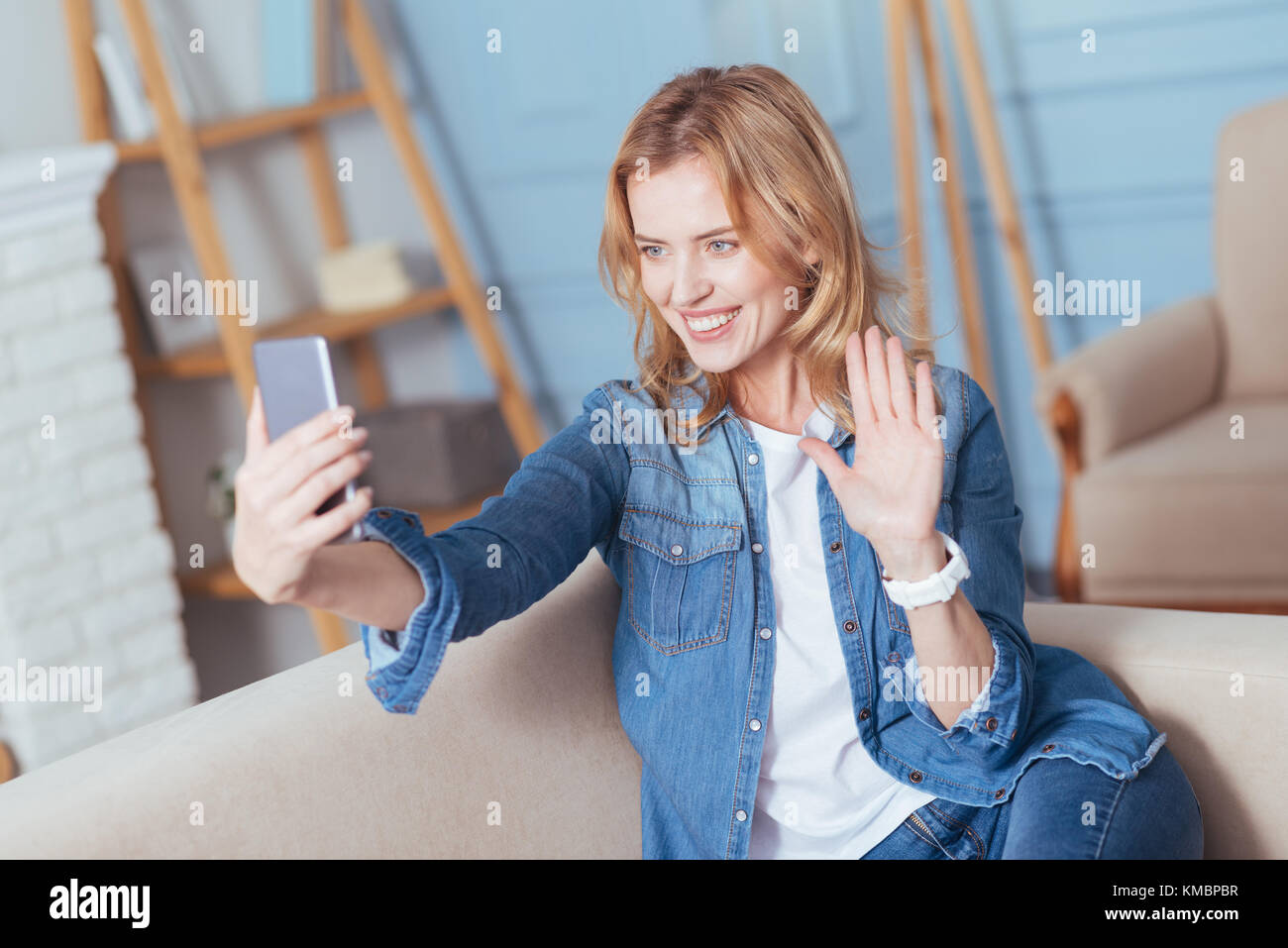 Happy young woman smiling while having a video call with a friend Stock ...