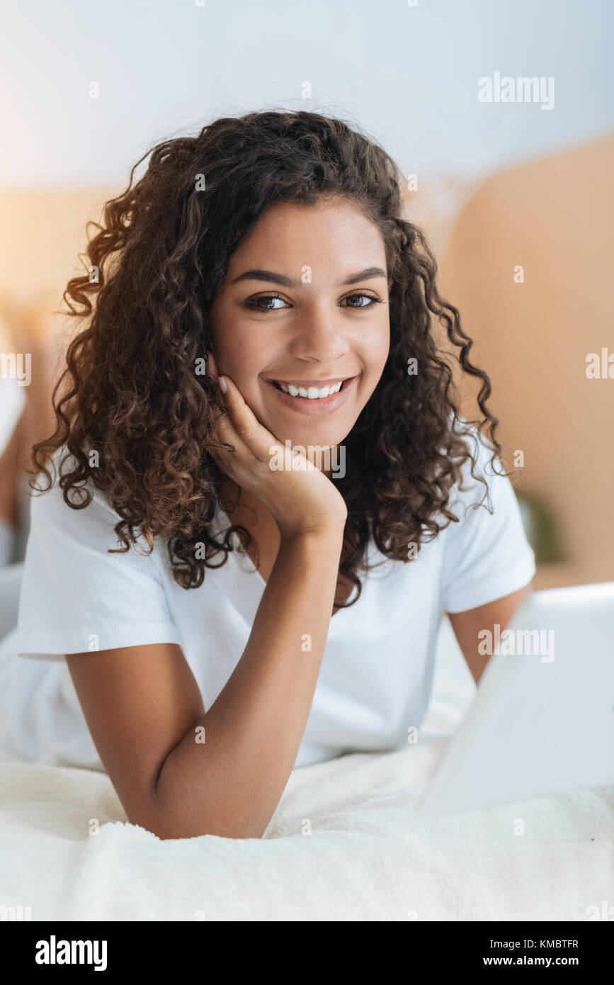 Beautiful curly haired girl smiling into camera Stock Photo - Alamy