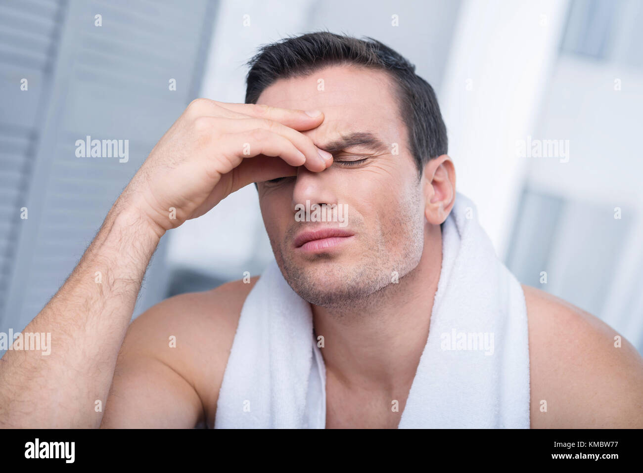 Pretty Strong Man Massaging His Nose Bridge Stock Photo 167447707