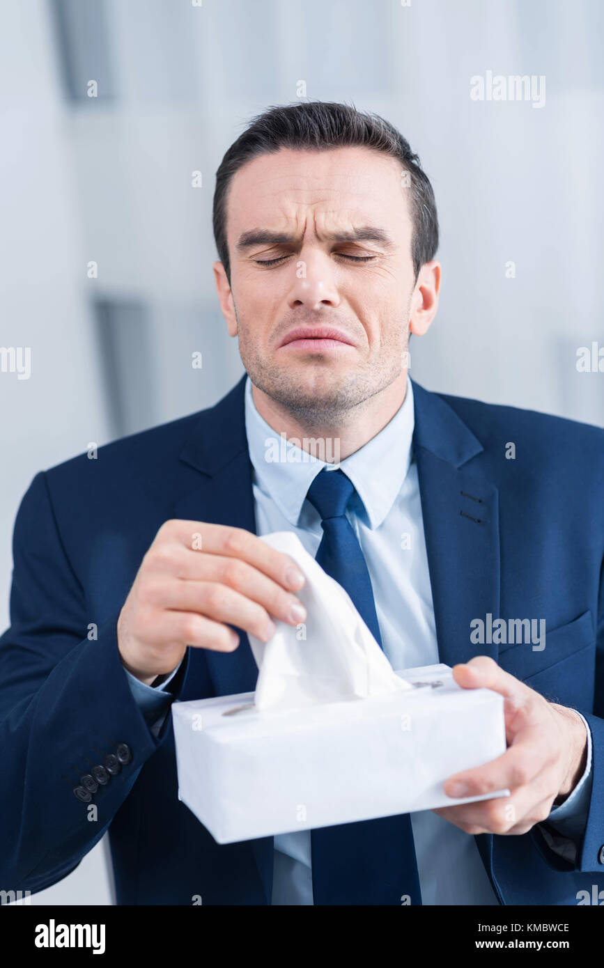Funny attractive man catching cold Stock Photo Alamy