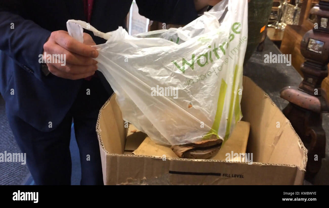 Video grab of Auctioneer Charles Hanson with a pair of sandals worn by Lawrence of Arabia which were found in a Waitrose carrier bag in Derbyshire. Stock Photo